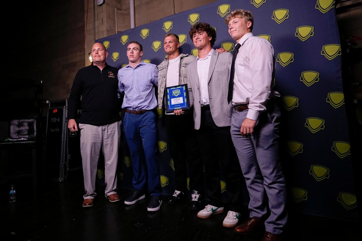 Watterson football coach Brian Kennedy and his players take a photo with Ohio State quarterback Lincoln Kienholz, center, after the Eagles were named the Boys Team of the Year during the Central Ohio High School Sports Awards on June 20 at Mershon Auditorium. Kienholz was the guest speaker.