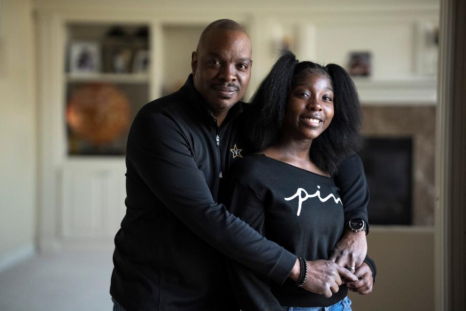 Feb 3, 2023; Blacklick, Ohio, USA;  Jewel Woods, founder of Male Behavioral Health, hugs his daughter Aba Woods, 12, while standing for a portrait in their home on Friday evening. Mandatory Credit: Joseph Scheller-The Columbus Dispatch