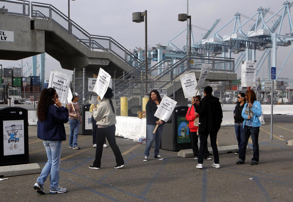 Striking protestors are shown at the Port of Los Angeles Wednesday Nov. 28, 2012 in Los Angeles. Striking workers shut down the largest terminal at the Port of Los Angeles for a second day on Wednesday, ignoring an arbitrator's order to return to work and raising the possibility of a larger job action that could paralyze the nation's busiest port complex. (AP Photo/Nick Ut)