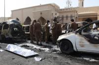 The remains of a body lie on a stretcher as Saudi security forces inspect the site of a suicide bombing that targeted the Shiite Al-Anoud mosque in the coastal city of Dammam, on May 29, 2015