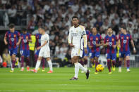 Real Madrid's Jude Bellingham, center, reacts as Barcelona players celebrate after their teammate Andreas Christensen scores his side's opening goal during the Spanish La Liga soccer match between Real Madrid and Barcelona at the Santiago Bernabeu stadium in Madrid, Spain, Sunday, April 21, 2024. (AP Photo/Manu Fernandez)