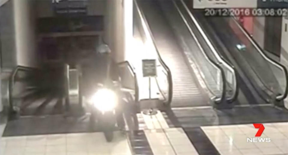 CCTV footage appears to show “The ATM Bomber” Vincent Graalman racing up a supermarket travelator on a scooter. Source: 7 News