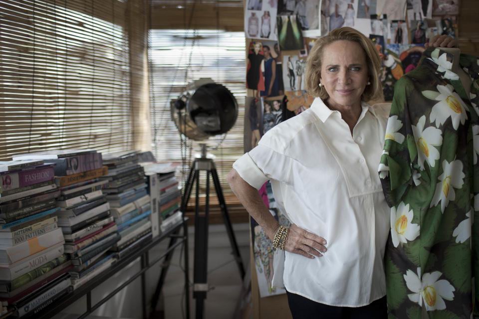 In this Feb. 26, 2013 photo, Brazilian designer Lenny Niemeyer poses for a photo in her office in Rio de Janeiro, Brazil. Before she became Brazil's bikini queen, with an empire of chic boutiques and legions of VIP fans, Niemeyer was locked away in her garage, making swimwear from scraps of used cloth and sliced cow bones. Known for her use of muted earth tones and the clean, almost architectural lines of her swimwear, Niemeyer sells some 350,000 pieces a year, mostly at her 26 boutiques throughout the country, but also at multi-mark shops in Britain, France, the Bahamas and in 23 U.S. states. (AP Photo/Felipe Dana)