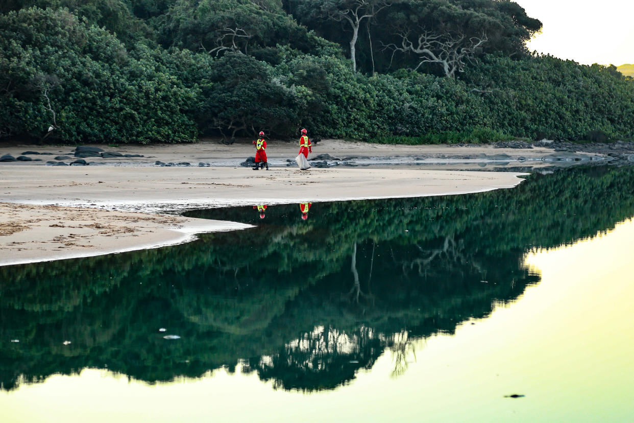 Image: Crews clean up aquatic life in the Umhlanga Lagoon north of Durban, South Africa, after a fire at a nearby chemical plant seeped toxins into the water system. (Linda Givetash / for NBC News)