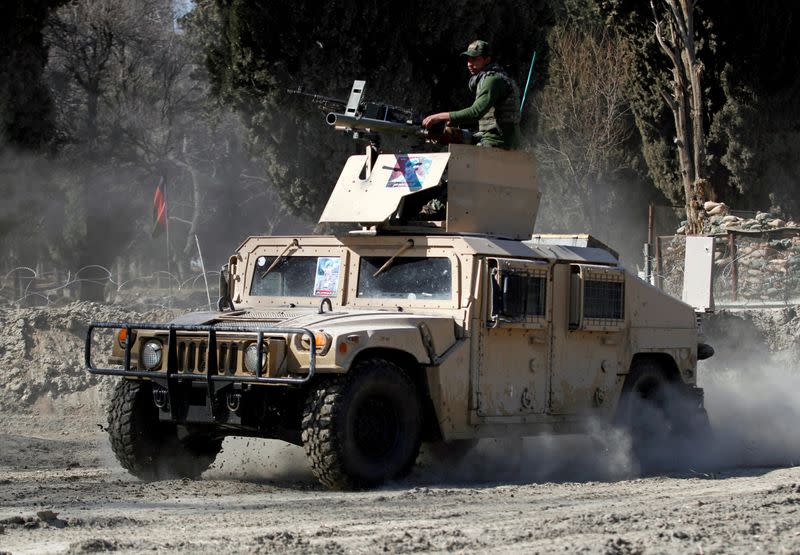 FILE PHOTO: An armoured vehicle patrols near the side of an incident where two U.S soldiers were killed a day before in Shirzad district of Nangarhar province