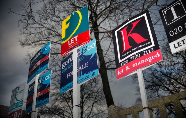 Estate agents’ boards are displayed outside flats on Poynders Road, south London