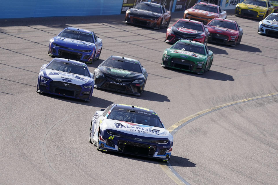 William Byron leads the rest of drivers around the track after winning a NASCAR Cup Series auto race at Phoenix Raceway, Sunday, March 12, 2023, in Avondale, Ariz. (AP Photo/Darryl Webb)