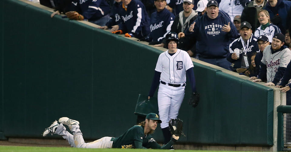 Josh Reddick #16 of the Oakland Athletics dives and makes the catch on the line drive from Austin Jackson #14 of the Detroit Tigers during the fifth inning of Game One of the American League Division Series against the Detroit Tigers at Comerica Park on October 6, 2012 in Detroit, Michigan. The Tigers defeated the Athletics 3-1. (Photo by Leon Halip/Getty Images)