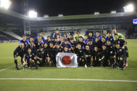 Japan's players pose for a photo after the U-23 Asian Cup semi-final match between Iraq and Japan in Doha, Qatar, on Monday, April 29, 2024. (AP Photo/Hussein Sayed)