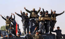 Federal police react as they arrive in Albu Saif, which was recently retaken by Iraqi military forces, south of Mosul, Iraq February 22, 2017. REUTERS/Zohra Bensemra