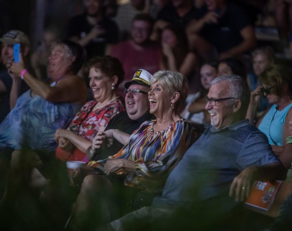 Audience members laugh as a hypnotist performs on the first day of the combined Wilson County Fair and Tennessee State Fair in Lebanon Thursday, August 12, 2021.