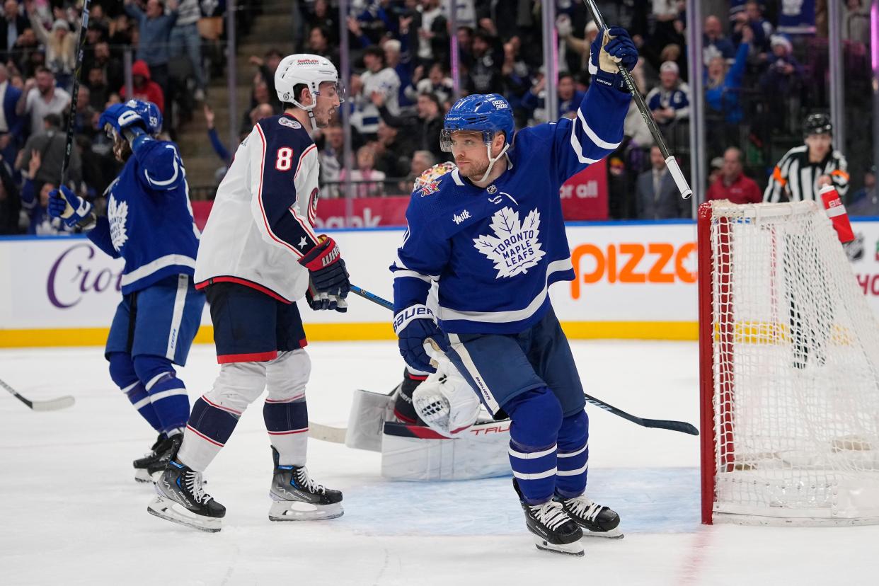 Dec 14, 2023; Toronto, Ontario, CAN; Toronto Maple Leafs forward Max Domi (11) reacts after a goal by defenseman Jake McCabe (not pictured) as Columbus Blue Jackets defeneseman Zach Werenski (8) retrieves the puck out of the net during the third period at Scotiabank Arena. Mandatory Credit: John E. Sokolowski-USA TODAY Sports
