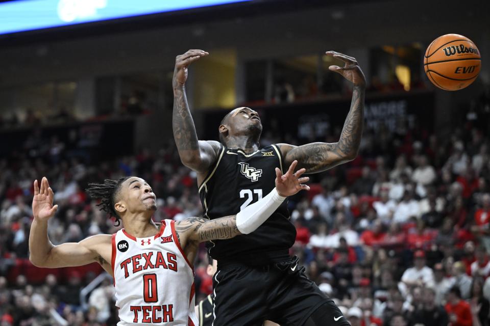 Texas Tech guard Chance McMillian (0) and Central Florida forward C.J. Walker (21) reach for a rebound during the first half of an NCAA college basketball game, Saturday, Feb. 10, 2024, in Lubbock, Texas. (AP Photo/Justin Rex)
