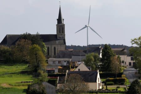 FILE PHOTO: An ECO 110 wind turbine manufactured by Alstom is seen in the Landes de Couesme wind farm near La Gacilly seen near the church in Saint-Nicolas-du-Tertre, western France, April 26, 2014.  Picture taken April 26, 2014.    REUTERS/Stephane Mahe/File Photo