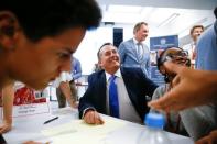 Britain's Secretary of State for International Trade Liam Fox visits students taking part in a mock trade negotiation at Harris Westminster Sixth Form college in central London