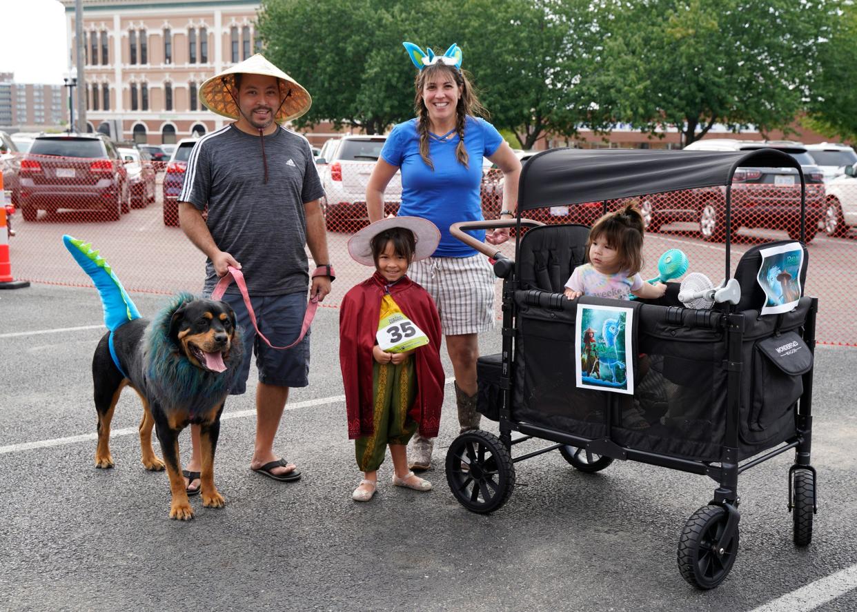 Zola and family Ted Pregitzer, Clara, Megan, and Ada, all of Adrian, are dressed as characters from the movie "Raya and the Last Dragon" for the 2021 pet parade during First Fridays in downtown Adrian.