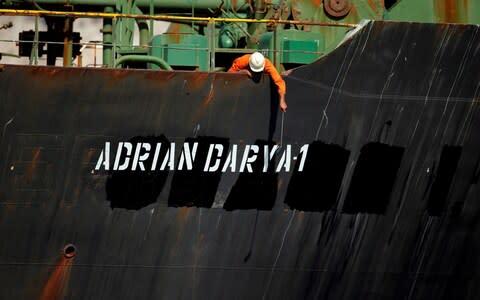 A crew member takes pictures with a mobile phone on Iranian oil tanker Adrian Darya 1 - Credit: &nbsp;JON NAZCA/&nbsp;REUTERS