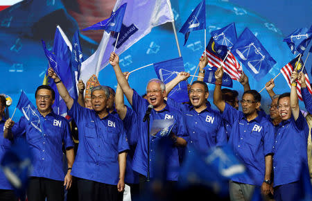 Malaysia's Prime Minister and president of ruling party National Front, Najib Razak and other party leaders wave the party flags during the launch of its manifesto for the upcoming general elections in Kuala Lumpur, Malaysia April 7, 2018. REUTERS/Lai Seng Sin