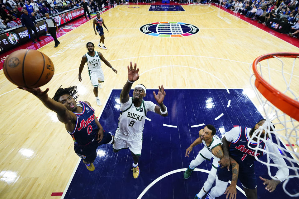 Philadelphia 76ers' Tyrese Maxey (0) goes up for a shot in front of Milwaukee Bucks' Bobby Portis (9) during the second half of an NBA basketball game, Tuesday, Nov. 9, 2021, in Philadelphia. (AP Photo/Matt Slocum)