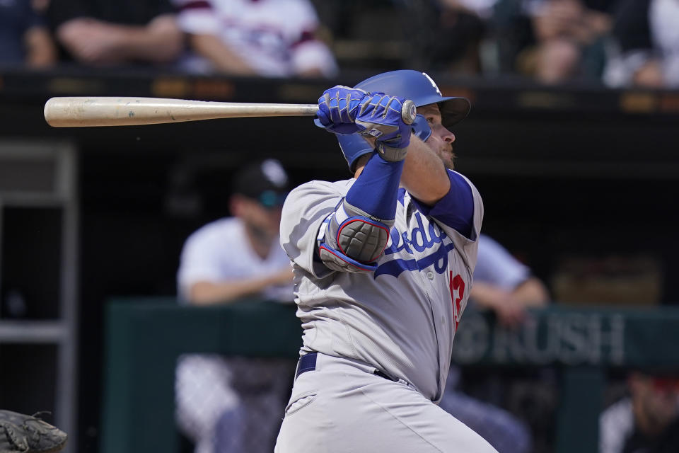 Los Angeles Dodgers' Max Muncy (13) watches his three-run home run off Chicago White Sox relief pitcher Bennett Sousa during the sixth inning of a baseball game Thursday, June 9, 2022, in Chicago. (AP Photo/Charles Rex Arbogast)