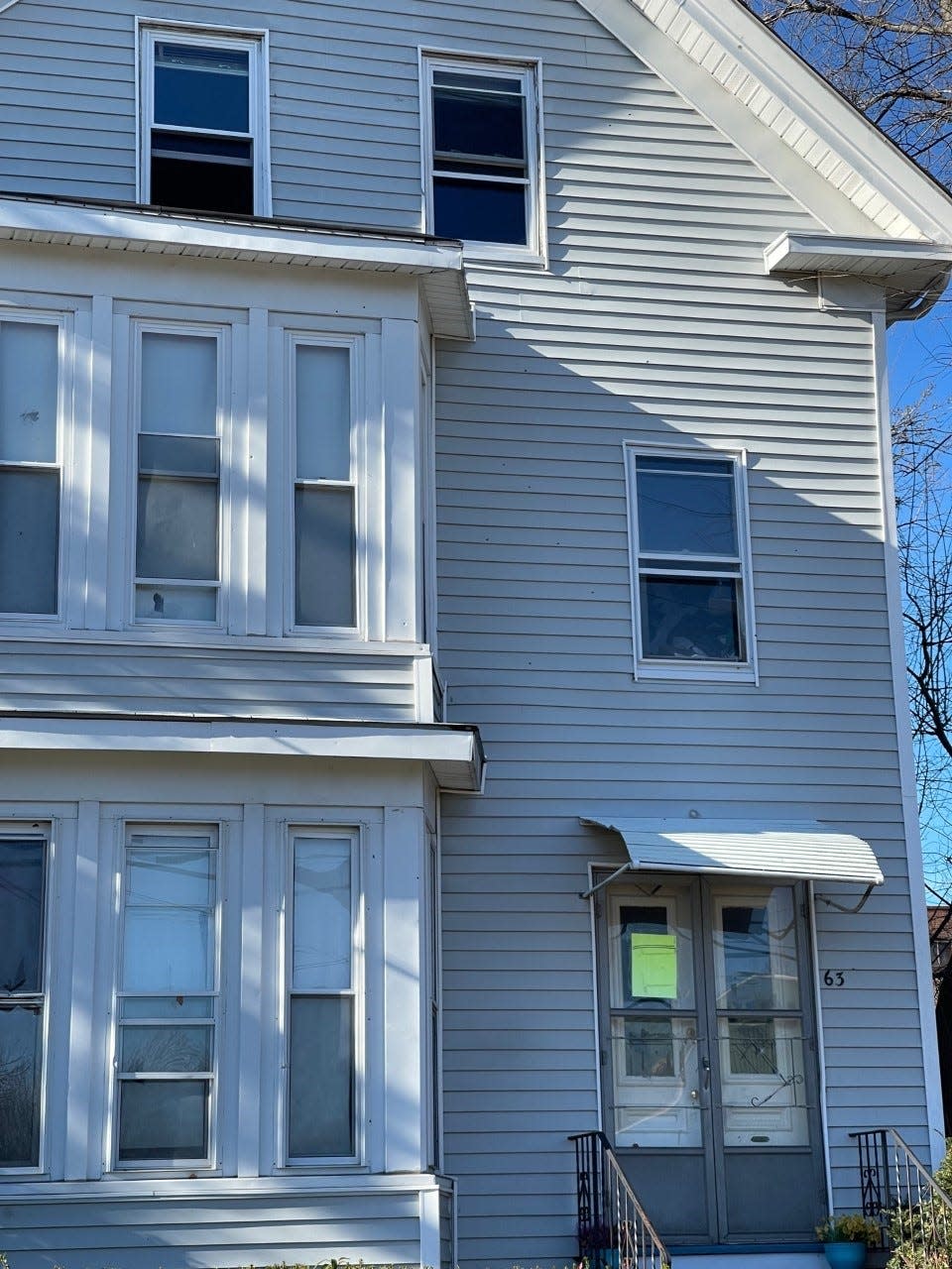 63 Perkins St., as seen Dec. 2 with what appear to be bullet holes in the siding.