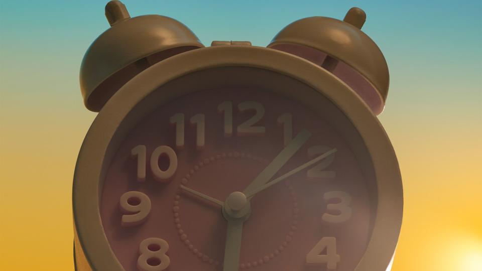alarm clock with a sunrise background