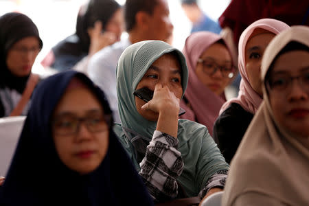 Relatives of passengers on the crashed Lion Air flight JT610 wait at Bhayangkara R. Said Sukanto hospital in Jakarta, Indonesia, October 30, 2018. REUTERS/Willy Kurniawan