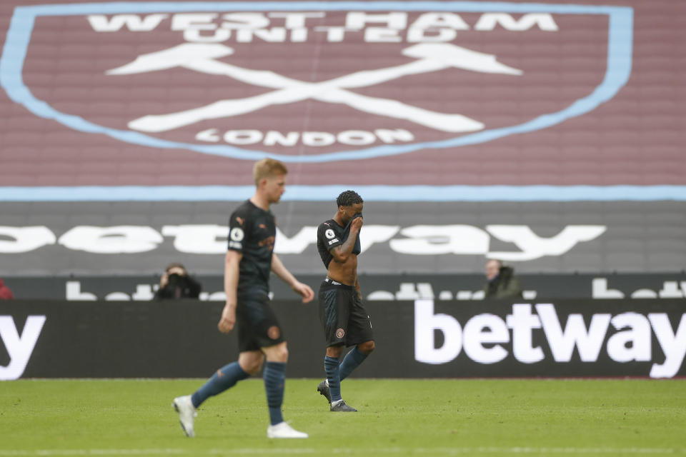 Manchester City's Raheem Sterling, right, and Kevin De Bruyne walk off the pitch at the end of the English Premier League soccer match between West Ham and Manchester City, at the London Olympic Stadium Saturday, Oct. 24, 2020. The game ended in a 1-1 draw. (Paul Childs, Pool via AP)