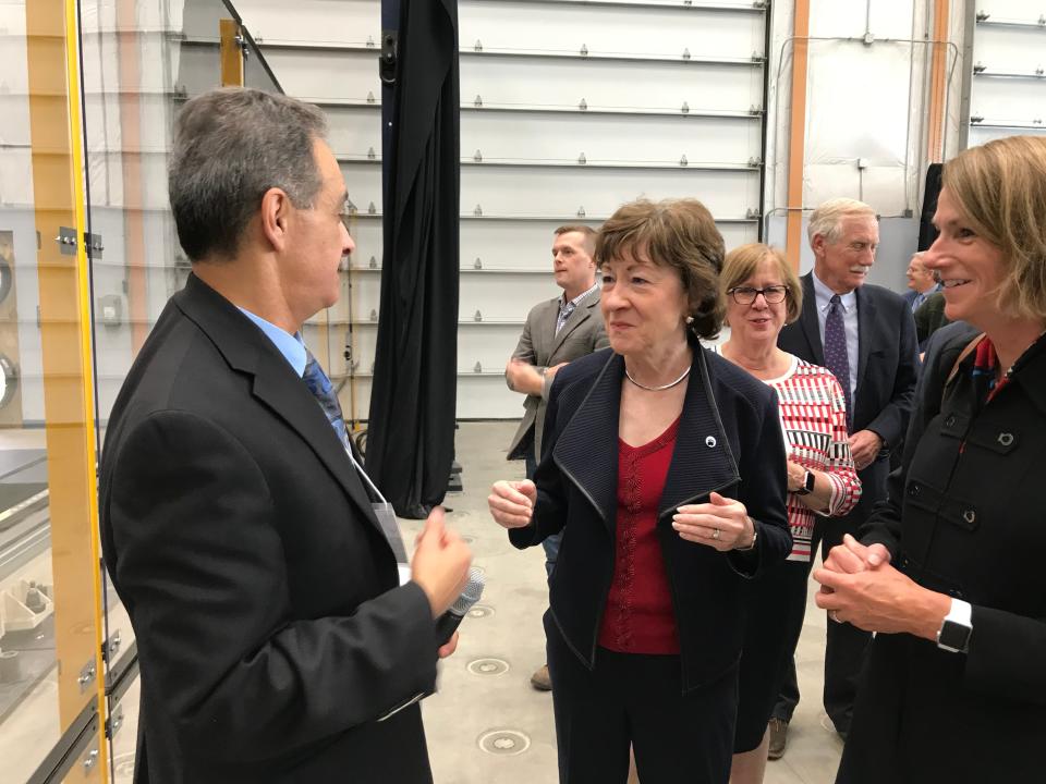 U.S. Sen Susan Collins talks to Habib Dagher, executive director of the University of Maine’s Advanced Structures and Composites Center, on Thursday following the school's unveiling of the world's largest 3D printer.