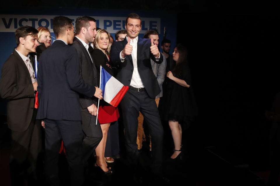 Far-right National Party top of the list for the European elections Jordan Bardella, center, thumbs up at the campaign headquarters, Sunday, May 26, 2019 in Paris. French polling agency estimates show far-right National Rally expected to beat Macron's party in European elections. (AP Photo/Thibault Camus)