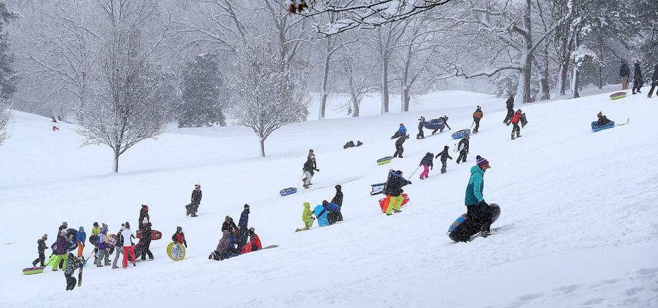 Local kids take advantage of a fresh snowfall by sledding the South Shore Country Club in Hingham on Friday, Jan. 7, 2022.