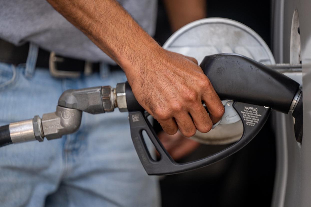 Hand on gas pump handle