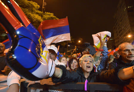 Supporters of Frente Amplio party react as elected President Tabare Vazquez gives his speech in Montevideo after knowing the results of a runoff election, November 30, 2014. REUTERS/Carlos Pazos