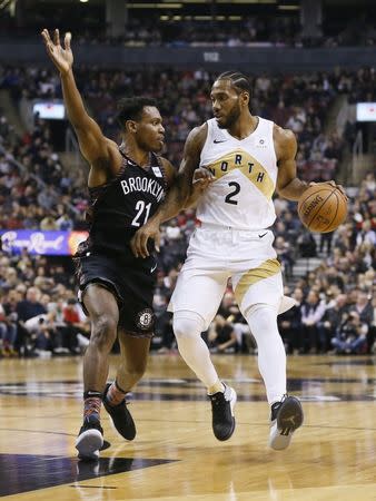 Jan 11, 2019; Toronto, Ontario, CAN; Toronto Raptors forward Kawhi Leonard (2) keeps the ball away from Brooklyn Nets forward Treveon Graham (21) at Scotiabank Arena. Mandatory Credit: John E. Sokolowski-USA TODAY Sports