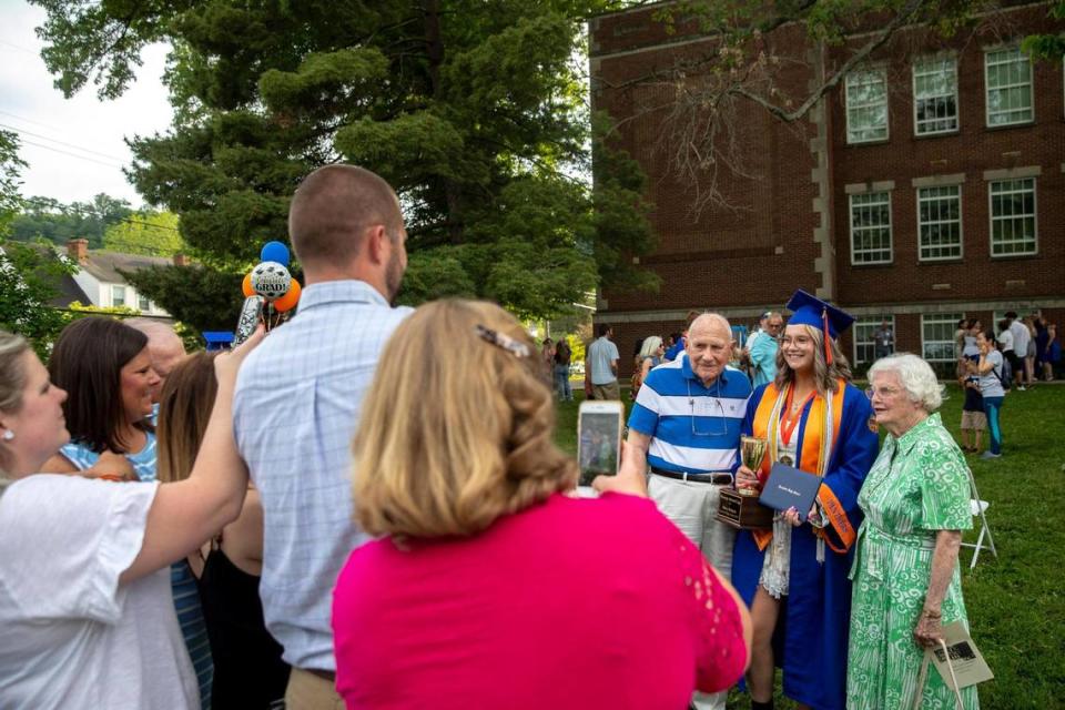 After her graduation ceremony outside Frankfort High School on Friday, May 21, 2021, Macy Dungan poses for pictures with her grandparents, Bruce and Peggy Dungan, who themselves are Frankfort High graduates.