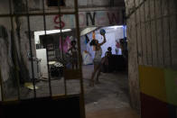 Residents play basketball at the squat known as Casa Nem, occupied by members of the LGBTQ community who are in self-quarantine as a protective measure against the new coronavirus, in Rio de Janeiro, Brazil, Friday, May 29, 2020. Casa Nem became a shelter several years ago for LGBTQ victims of violence and those who, rejected by their families, have nowhere to live. (AP Photo/Silvia Izquierdo)