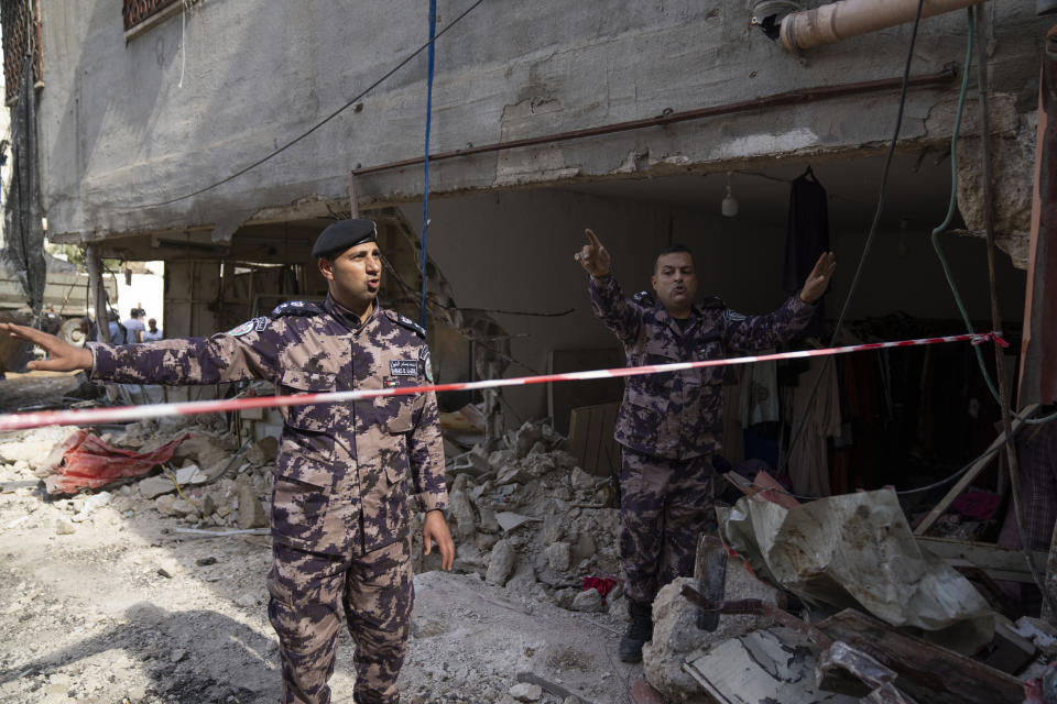 Palestinians security officers secure the parameter of damaged buildings in the West Bank refugee camp of Nur Shams, Tulkarem, Sunday, April 21, 2024. The Palestinian Red Crescent rescue service meanwhile said it has recovered more than a dozen of bodies from an Israeli raid in the Nur Shams urban refugee camp in the West Bank that began late Thursday. Those killed include three militants from the Islamic Jihad group and a 15-year-old boy.(AP Photo/Nasser Nasser)