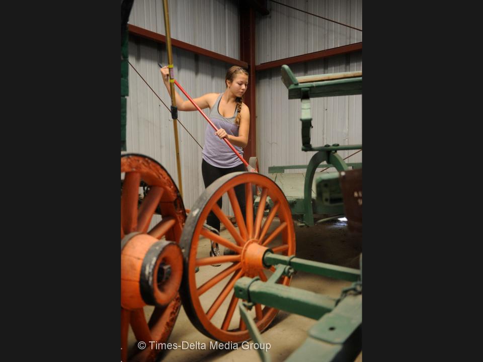 Emily Goldenstein, 15, wipes cobwebs in the Wagon Room at the Tulare County Museum in this 2015 file photo.