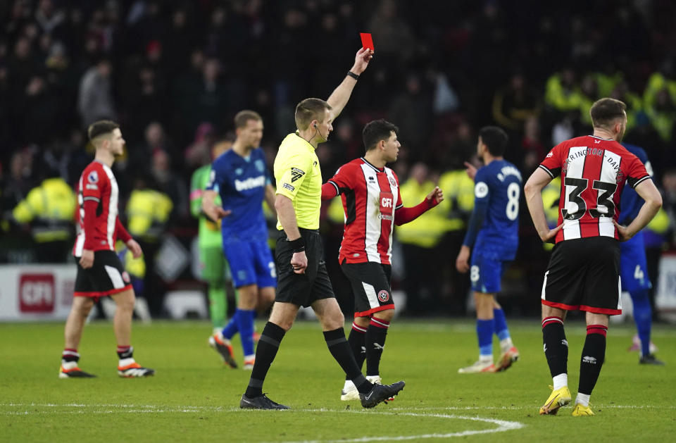 West Ham United's Vladimir Coufal is shown a red card by referee Michael Salisbury, during the English Premier League soccer match between Sheffield United and West Ham United at Bramall Lane, in Sheffield, England, Sunday, Jan. 21, 2024. (Nick Potts/PA via AP)