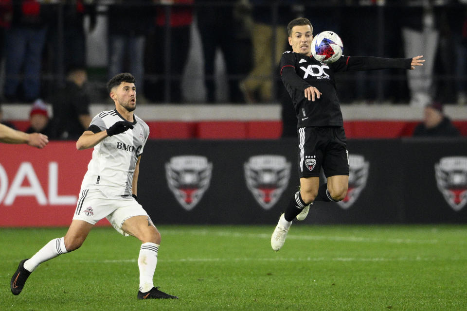 D.C. United defender Pedro Santos, right, leaps for the ball against Toronto FC midfielder Jonathan Osorio, left, during the second half of an MLS soccer match, Saturday, Feb. 25, 2023, in Washington. (AP Photo/Nick Wass)