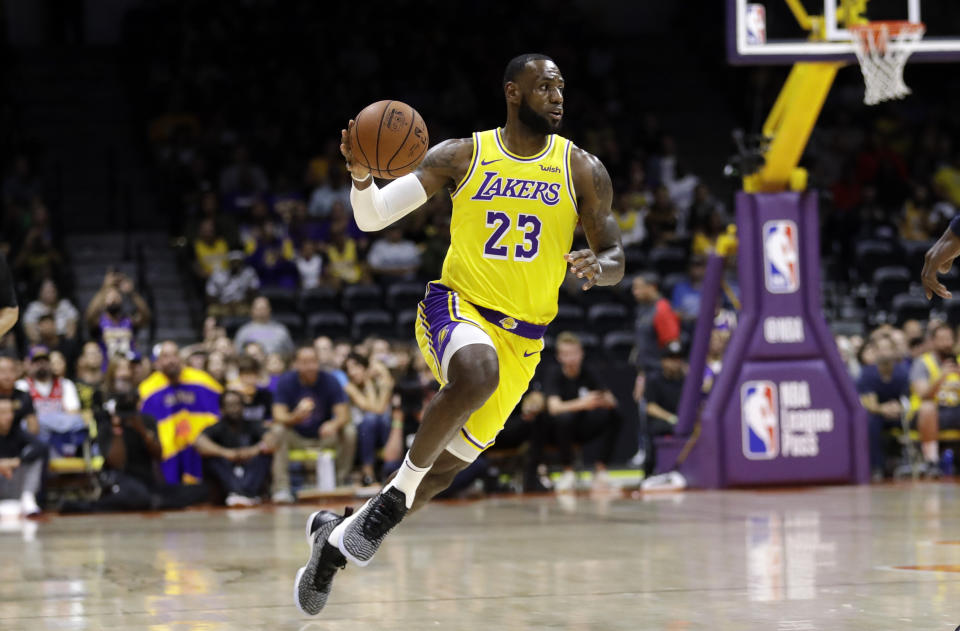 Los Angeles Lakers forward LeBron James dribbles during the first half of an NBA preseason basketball game against the Denver Nuggets, Sunday, Sept. 30, 2018, in San Diego. (AP Photo/Gregory Bull)