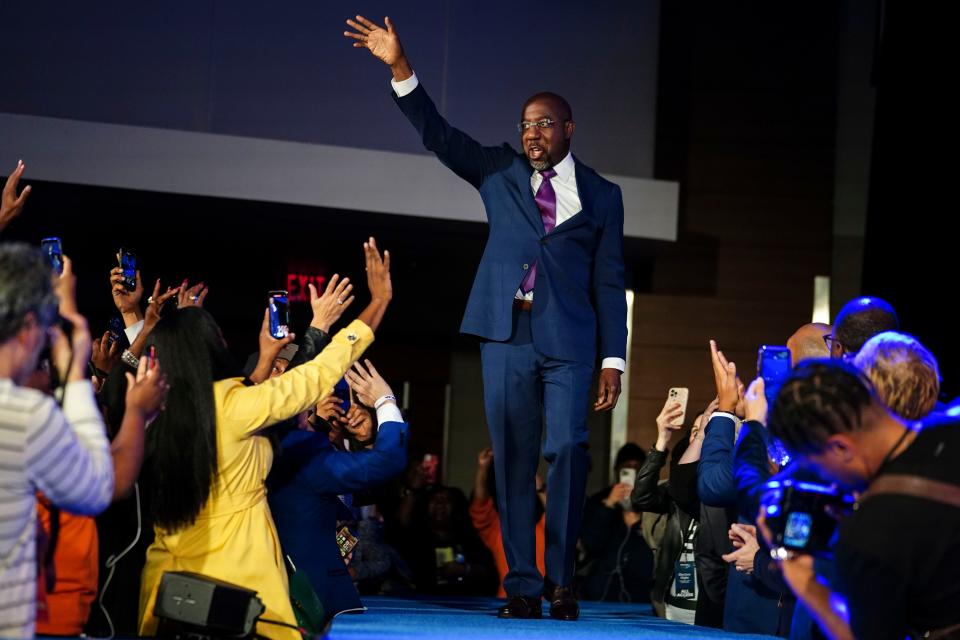 Democratic Sen. Raphael Warnock arrives to deliver his victory speech during an election night watch party,