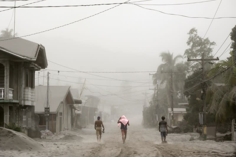 Residents living near the errupting Taal Volcano evacuate in Agoncillo, Batangas City