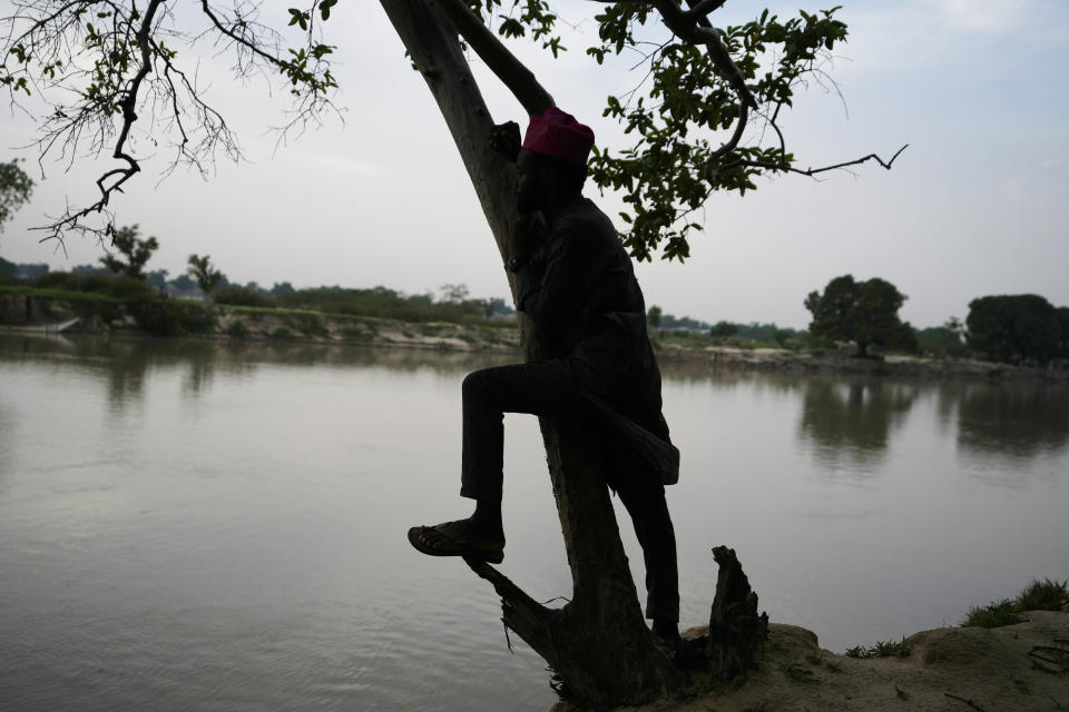 An atheist looks over the river Yobe in Gashua Nigeria Tuesday, July 11, 2023. Nonbelievers in Nigeria said they perennially have been treated as second-class citizens in the deeply religious country whose 210 million population is almost evenly divided between Christians dominant in the south and Muslims who are the majority in the north. Some nonbelievers say threats and attacks have worsened in the north since the leader of the Humanist Association of Nigeria, Mubarak Bala, was arrested and later jailed for blasphemy. (AP Photo/Sunday Alamba)