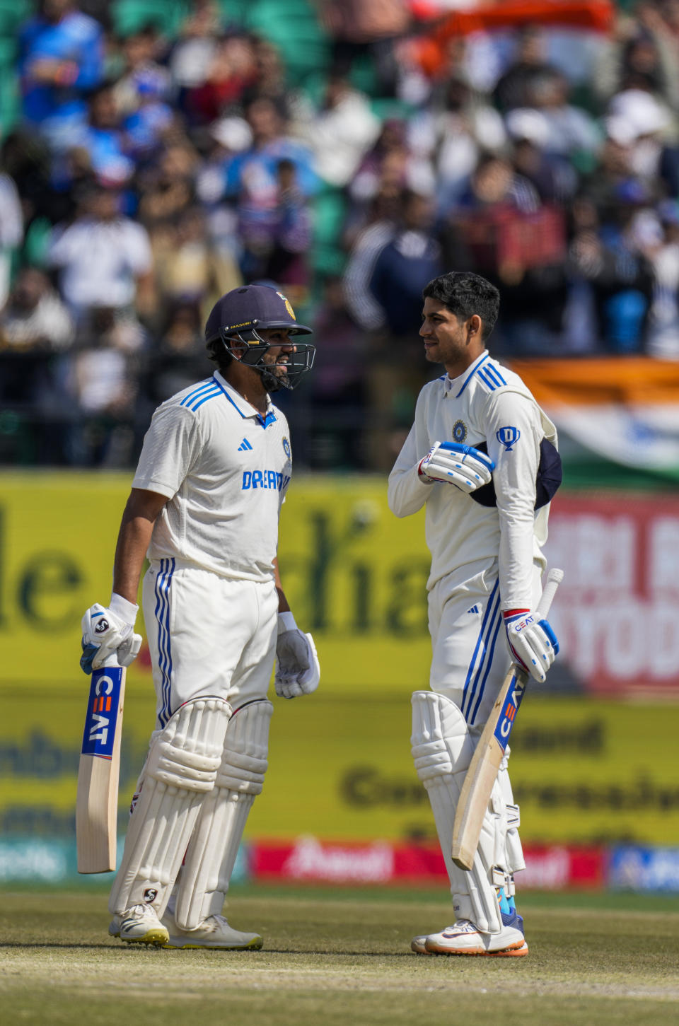 India's Shubman Gill, right celebrates his hundred runs with captain Rohit Sharma on the second day of the fifth and final test match between England and India in Dharamshala, India, Friday, March 8, 2024. (AP Photo/Ashwini Bhatia)