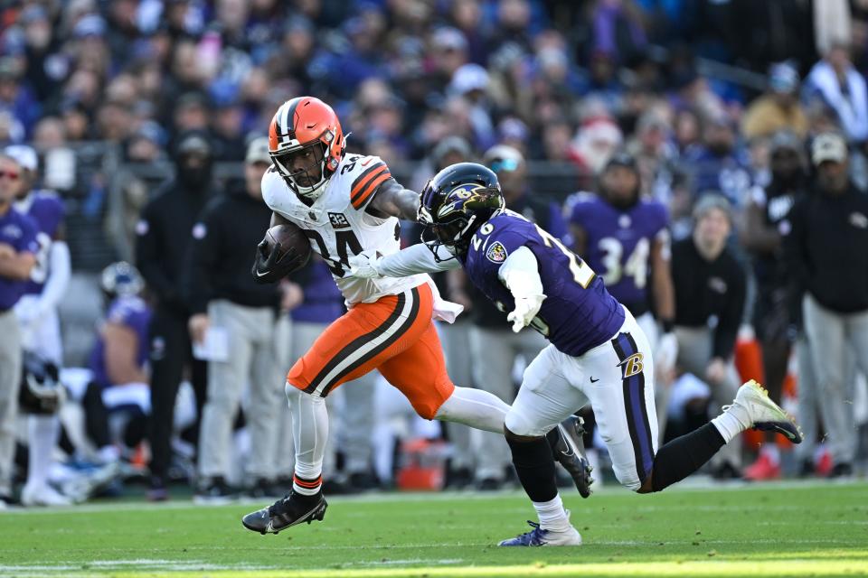 Cleveland Browns running back Jerome Ford (34) runs the ball and stiff arms Baltimore Ravens safety Geno Stone (26) on Nov. 12, 2023, in Baltimore.