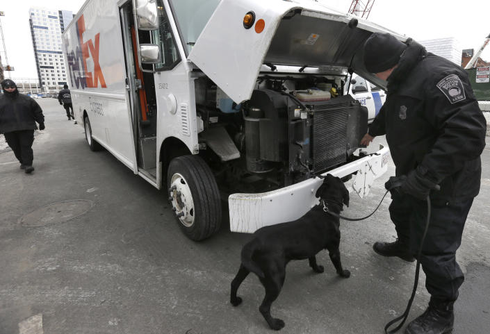 Boston Police Special Operations officers use a bomb-sniffing dog while searching a vehicle on a street near the federal courthouse, in Boston, Tuesday, March 3, 2015. A panel of 12 jurors and six alternates was seated Tuesday after two months of jury selection for the federal death penalty trial of Boston Marathon bombing suspect Dzhokhar Tsarnaev. (AP Photo/Steven Senne)