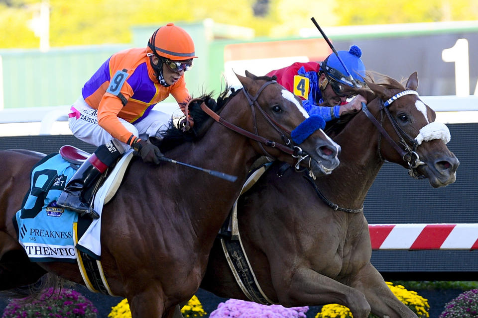 Swiss Skydiver, right, ridden by Robby Albarado, leads Authentic, ridden by John Velazquez, to win the 145th Preakness Stakes horse race at Pimlico Race Course, Saturday, Oct. 3, 2020, in Baltimore. (AP Photo/Nick Wass)