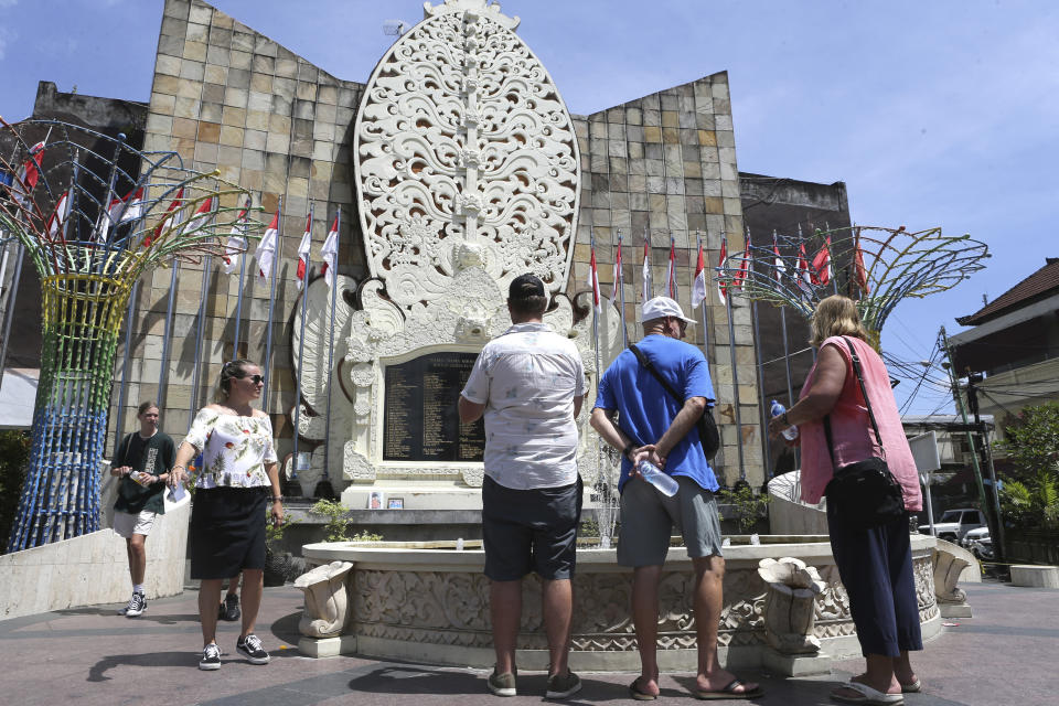 Foreign tourists visit the Bali Bombing Memorial Monument in Kuta, Bali, Indonesia on Thursday, Dec. 8, 2022. An Islamic militant convicted of making the explosives used in the 2002 attack that killed over 200 people was paroled Wednesday, after serving about half of his original 20-year prison sentence, despite strong objections by Australia, which lost scores of citizens in the Indonesian attacks. (AP Photo/Firdia Lisnawati)