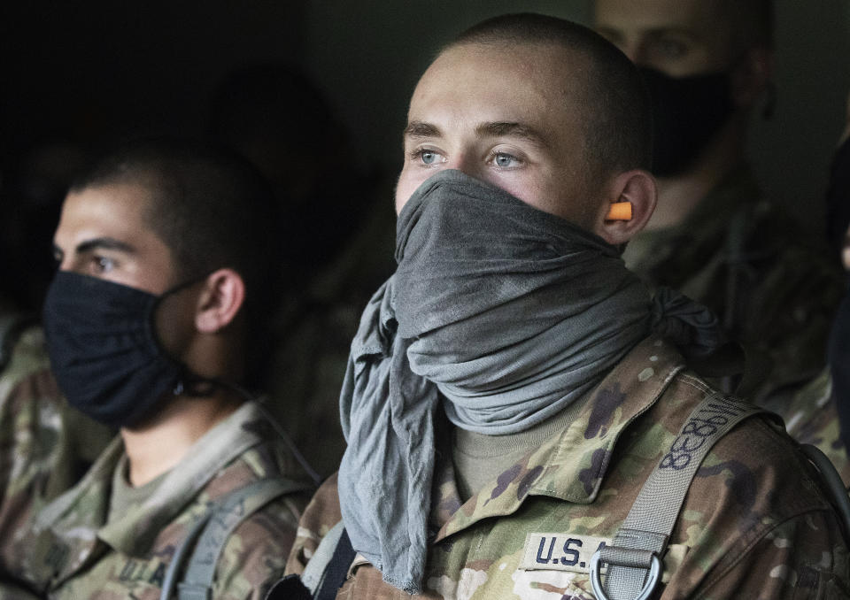 Cadets watch a hand grenade drill, Friday, Aug. 7, 2020, at the U.S. Military Academy in West Point, N.Y. The pandemic is not stopping summer training. Cadets had to wear masks this year for much of the training. (AP Photo/Mark Lennihan)